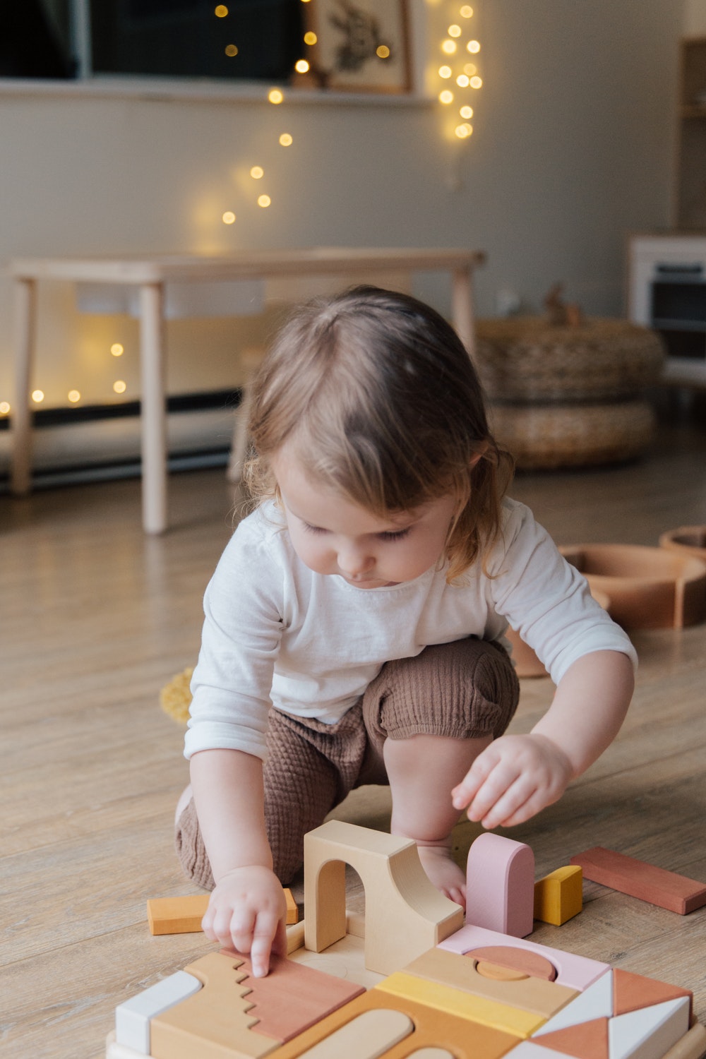 A young toddler engaged in a Montessori transferring activity